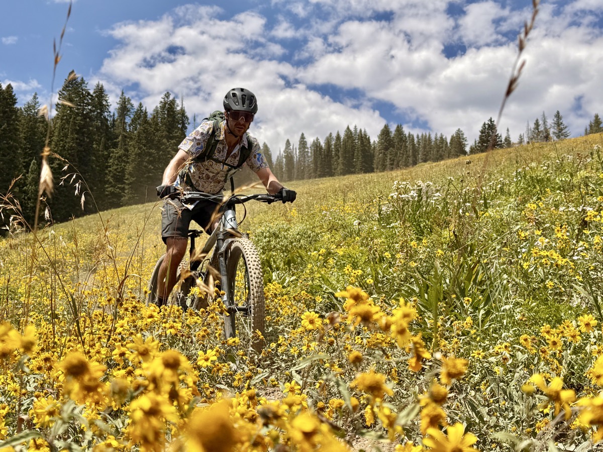 A rider dropping into desert singletrack during a FiresideCME trip