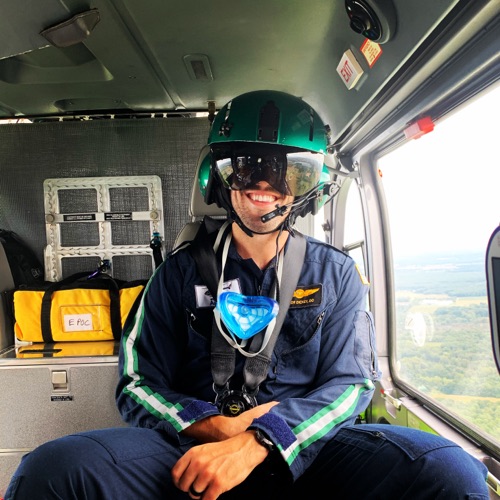 Taylor Dickey, DO, in flight gear aboard a medical helicopter